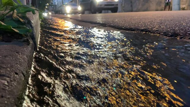 Rain flowing sewer system street. Storm sewer after a heavy rain.