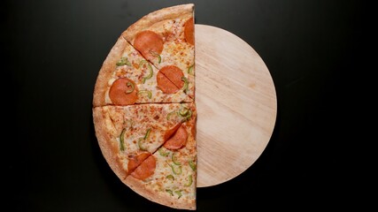 Half of Big Pizza on a black background, Top view