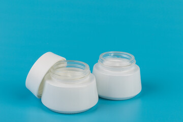 Beauty Cream Texture Close Up. Cosmetic Skincare Product In Jar On Blue Background. High Quality