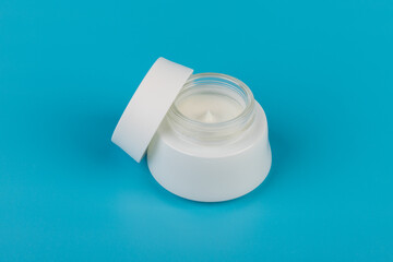 Beauty Cream Texture Close Up. Cosmetic Skincare Product In Jar On Blue Background. High Quality