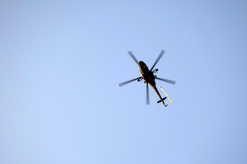 Fototapeta na wymiar Helicopter flying in clear sky.