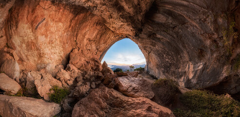 Interior of a large prehistoric cave, Sierra de Bernia, Alicante, Spain. Observing the beautiful views of the sea, altea, benidorm and alicante from inside a cave