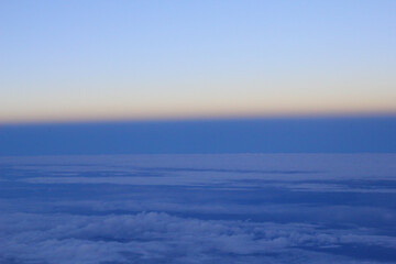 Tranquil scenery of the sunrise above the blue clouds for background or wallpaper