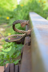 metal rusty cable on a railway rail