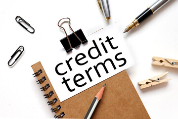 credit terms. the inscription on the business card is attached to the notebook.