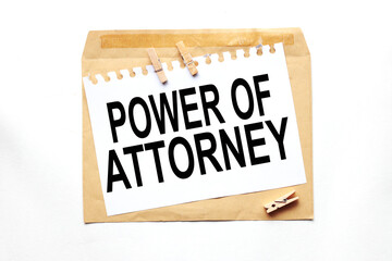 power of attorney. text on white paper on craft notebook