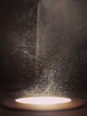 Vertical shot of moving dust particles in a light ray