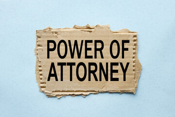 Power of Attorney. text on torn paper on blue background