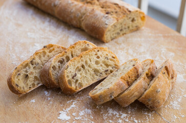 fresh loaf of bread on wooden board