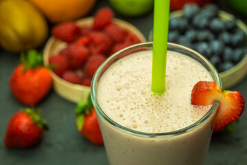 A glass of cool milkshake with fruit