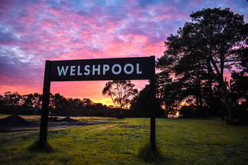Welshpool Signpost in front of sunset