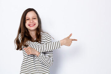 Funny dark-haired girl shows  gesture with her hands. On a light background. Space for text