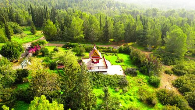Aerial Panning Shot Of Thai Pagoda Located Ben Shemen Forest, Drone Flying Over Green Trees
