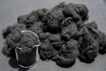 Black Polyester fiber or fabric  in beaker glass. Chemical concept 