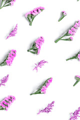 Fototapeta na wymiar spring design in pastel color with purple flowers top view pattern