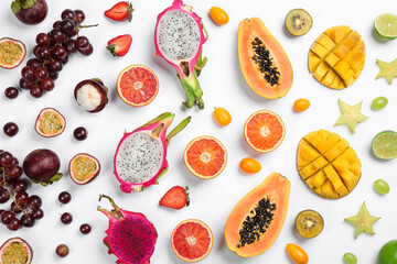 Many different delicious exotic fruits on white background, flat lay