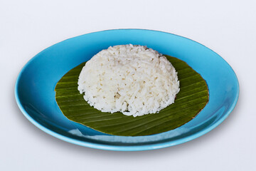 Rice on banana leaf in a disk isolated on white background.