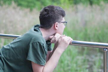 Teen guy on a walk in the park, fresh air and sports