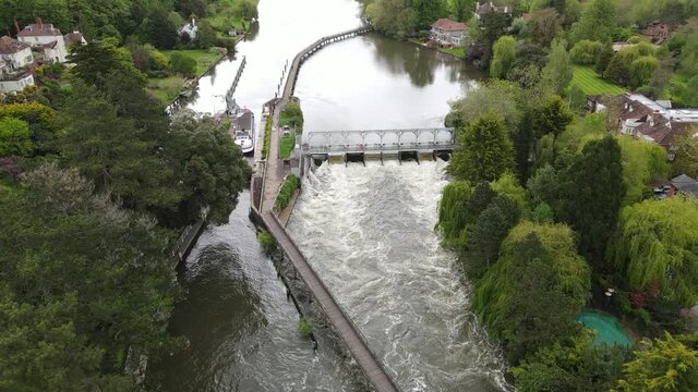 River Thames Henley weir and Lock Aerial view boat leaving lock.