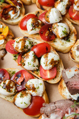 
A set of different snacks for a party or a festive table. Ciabatta sandwiches with tomatoes,...