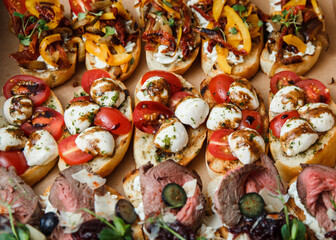 
A set of different snacks for a party or a festive table. Ciabatta sandwiches with tomatoes,...