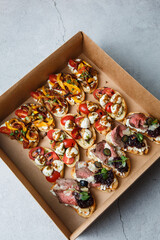 
A set of different snacks for a party or a festive table. Ciabatta sandwiches with tomatoes,...