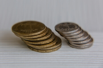 Ukrainian currency hryvnia coins on a white background. Ukrainian money. Inflation, business, economics and finance theme.