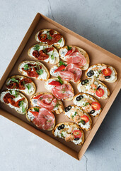 
A set of different snacks for a party or a festive table. Ciabatta sandwiches with tomatoes,...