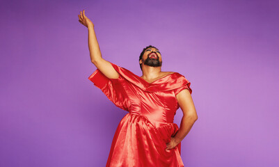 Drag queen singing on purple background