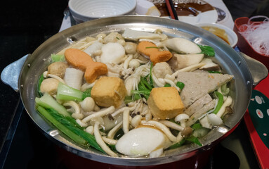 The Thai style shabu (mix meat and vegetable in the boiling soup) for ready to eat in the hot metal pot.