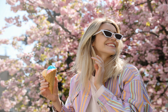 Young woman with icecream in beautiful park