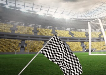 Black and white race flag on the pitch in a stadium with empty goal