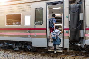 Concept life style travel or journey :  Father or brother Holding the hand of a child or brother Board the train To travel