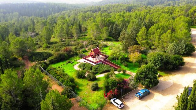 Aerial Shot Of Pagoda In Forest, Drone Ascending Over Famous Landscape On Sunny Day - Ben Shemen, Israel