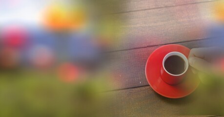 Composition of woman holding red cup of coffee over wooden surface with copy space