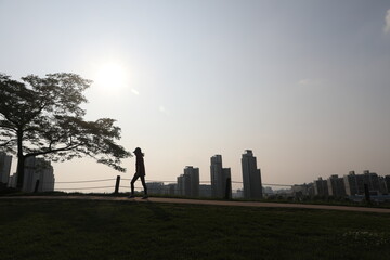 A jogger in the park at dusk