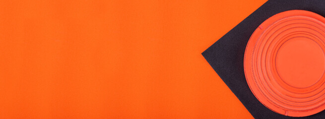 Web banner with clay target on black and orange geometric background. Skeet shooting © kcuxen