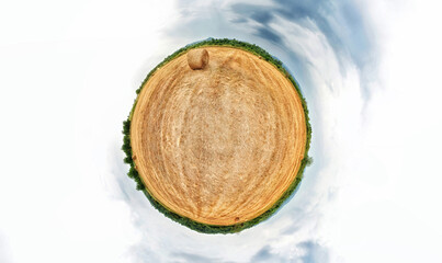 Stereographic projection of a a hay bale field. 360 degree panorama. Globe panorama.