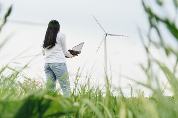 researcher analyzes readouts on wind power station