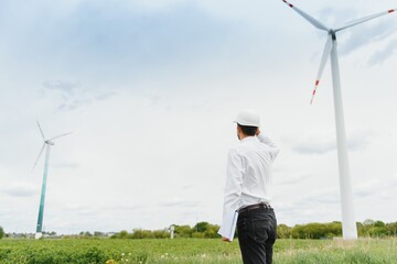 Engineer inspecting Project Manager at the Wind Farm. Man working in the enviromental