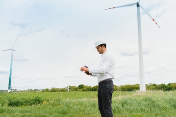 Engineer inspecting Project Manager at the Wind Farm. Man working in the enviromental