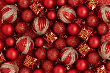 Christmas toys on a red glittering background. Festive texture concept.