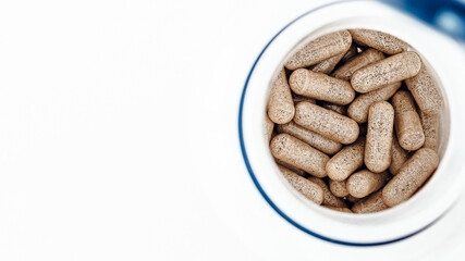 topview of super enzymes capsules in the jar, with negative space. dietary supplement copyspace. mental wellbeing and personal health concept