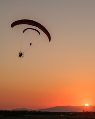 single paramotor show at sunset