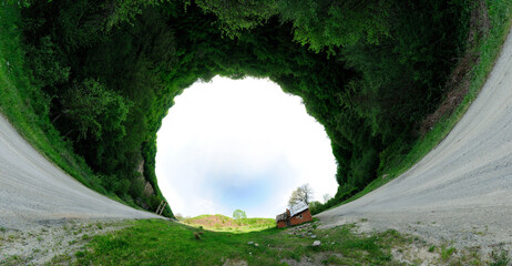 Stereographic panoramic projection of a house in the forest. 360 degree panorama. Very Wide angle shot.