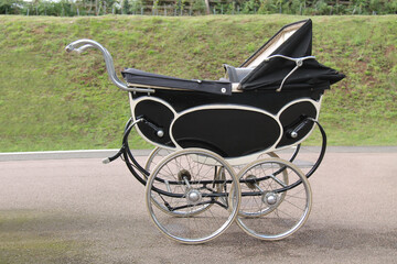 Fototapeta na wymiar A Four Wheeled Traditional Vintage Baby Pram.