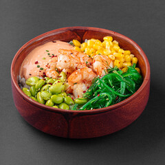 Hawaiian tuna poke bowl with vegetables on grey background