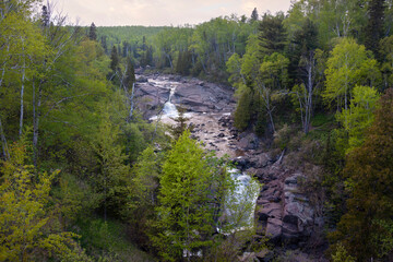 Fototapeta na wymiar High angle view of waterfall and trees along north shore of Lake Superior in Minnesota