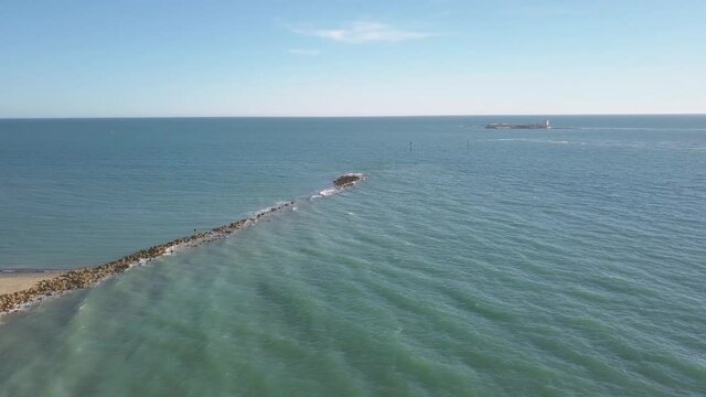 Aerial View Of Sancti-Petri Breakwater With Castle of Sancti-Petri In The Distance In Chiclana de la Frontera, Spain.
