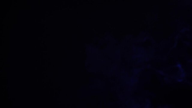 Blue and white smoke on black background slow motion 4k 60fps